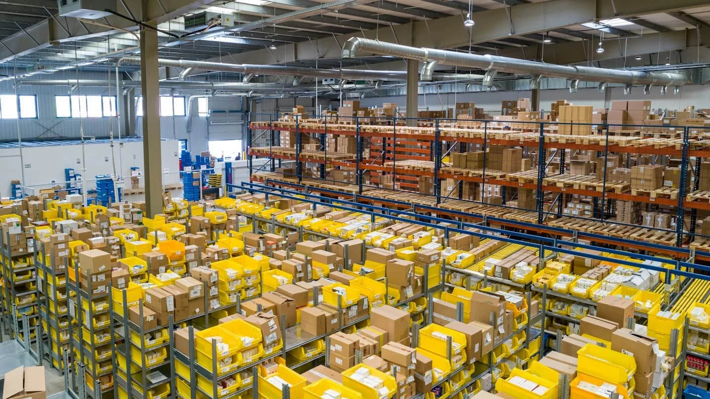 Stacked pallets of wholesale technology goods illustrating volume tier purchasing